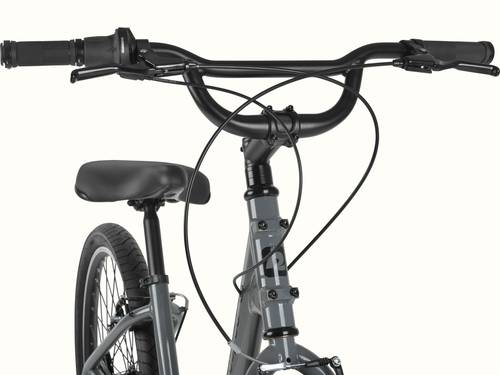 retrospec Montauk 26 handlebar detail featuring Shimano twist shifters, ergonomic grips, and a wide swept-back bar for a relaxed, upright ride.