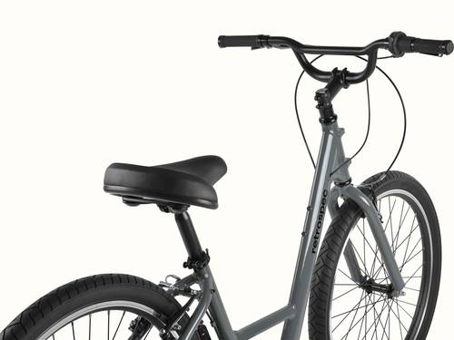 retrospec Montauk 26 comfort bike in Graphite, close-up of the cushioned saddle, swept-back black handlebar, and upright riding position against a clean background.