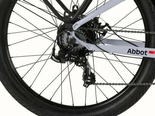 A close-up of the rear wheel of the Abbot Rev 2 EBike showcasing the Shimano 7-Speed Drivetrain with Abbot Rev logo.