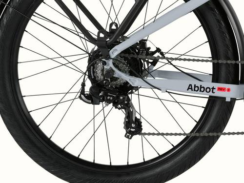 A close-up of the rear wheel of the Abbot Rev 2 EBike showcasing the Shimano 7-Speed Drivetrain with Abbot Rev logo.