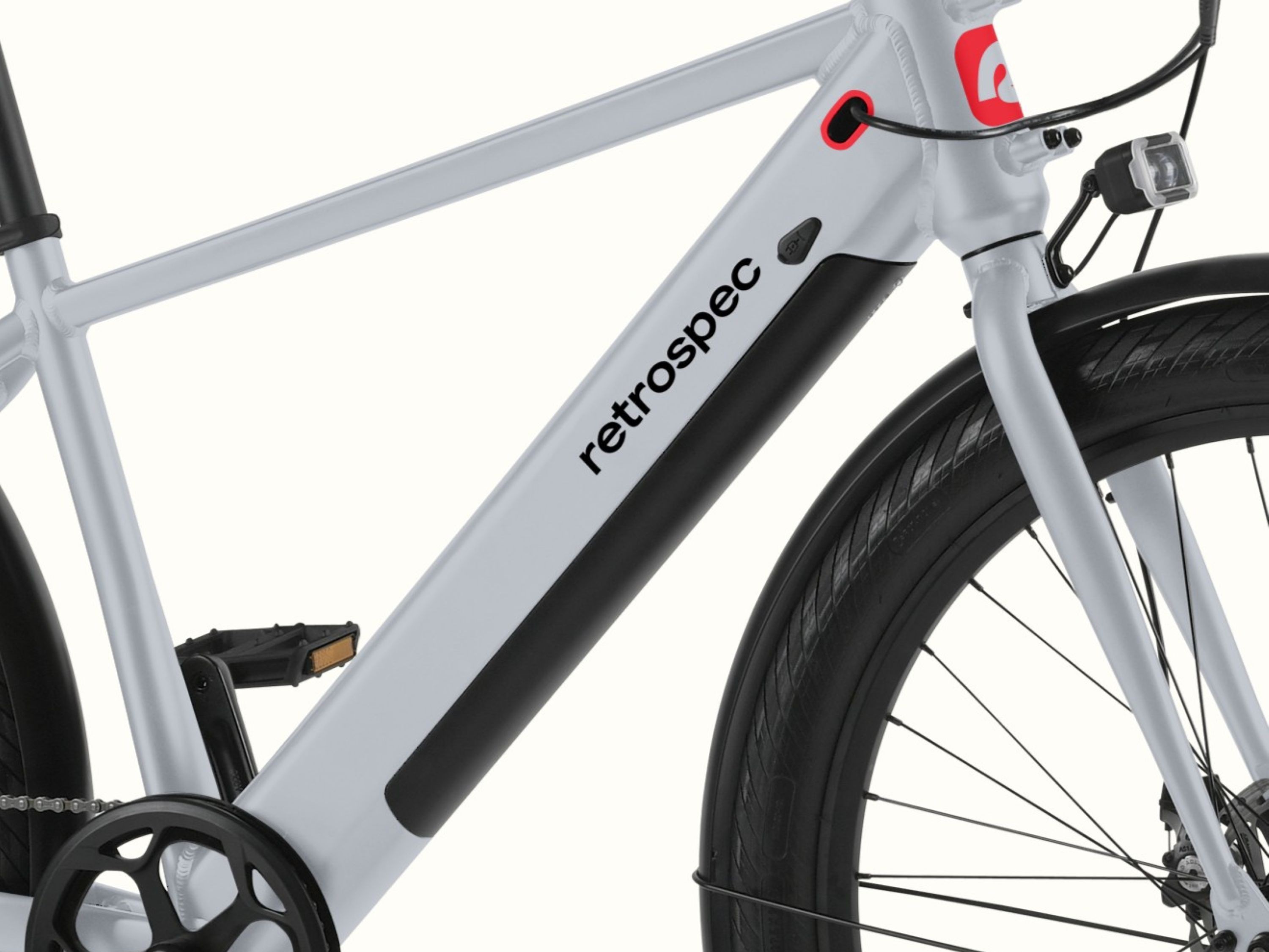 A close-up of frame and battery on the gray Abbot Rev 2 Commuter Electric Bike.