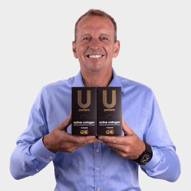 U Perform co-founder Professor Greg Whyte OBE holding 2 boxes of U Perform sports collagen Active Collagen No.1 Collagen Gel Sports Supplement for injury prevention and injury recovery