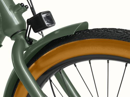 A close-up of the front fender and headlight on the green Beaumont Rev+ EBike. 