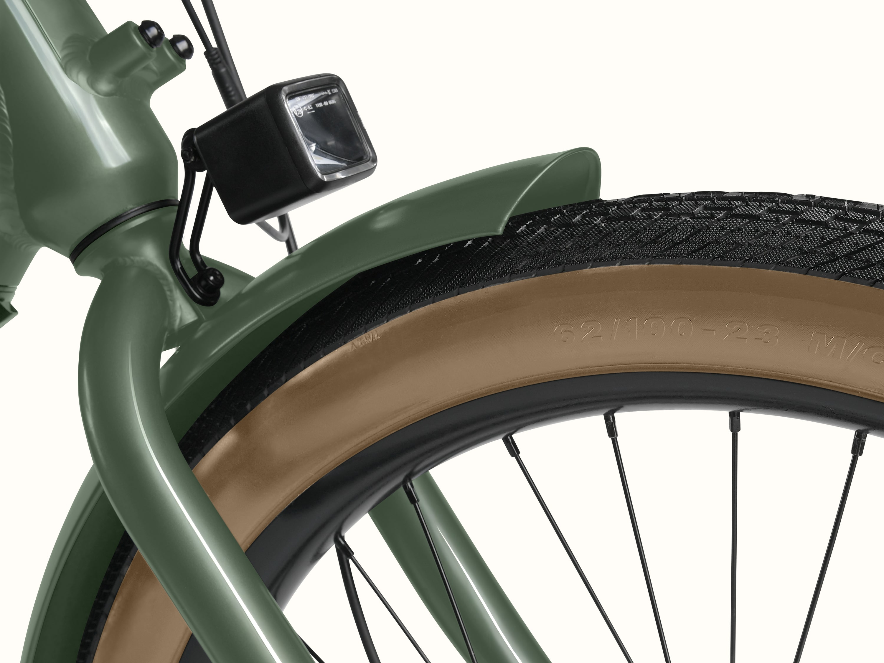 A close-up of the front fender and headlight on the green Beaumont Rev+ EBike. 