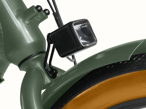 A close-up of the headlight on the Beaumont Rev+ EBike with view of the front fender over the black tire with brown sidewall.