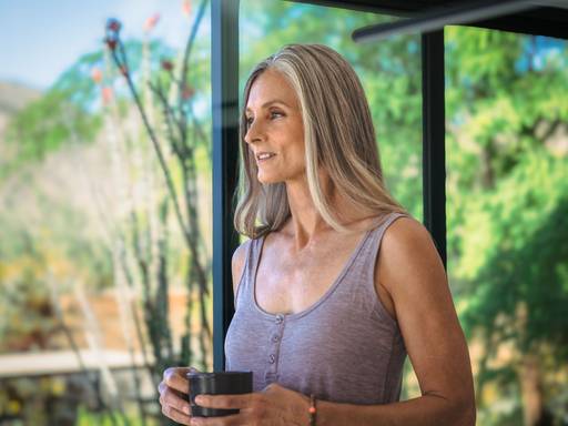 Women with a cup of coffee with enhanced hair volume and density.