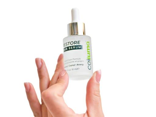 RESTORE Hair Serum bottle in hand ready for a targeted application to the scalp.