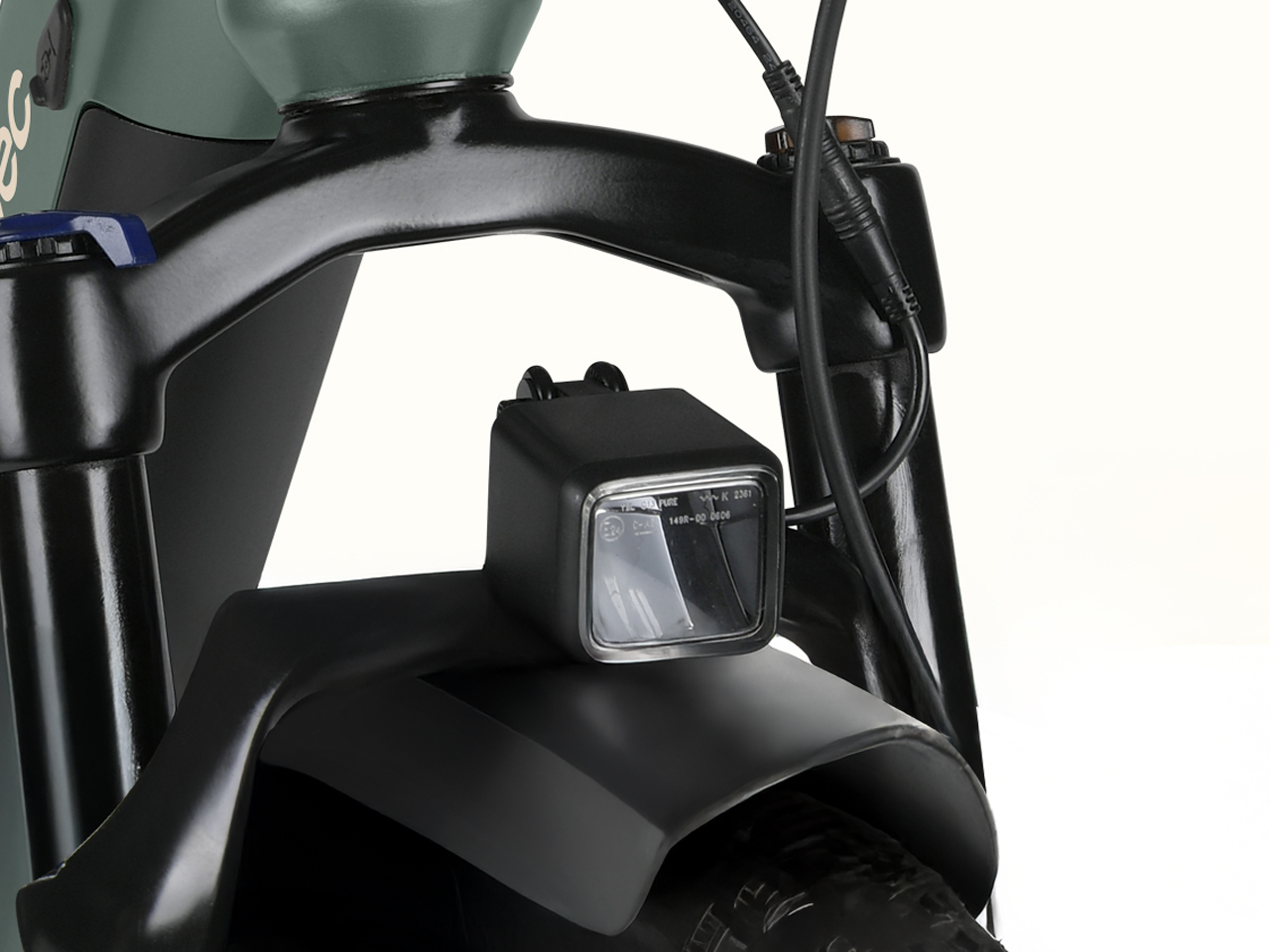 Close-up of the ebike's front fork with a mounted LED headlight, showcasing cables and a sleek black design against a light background.