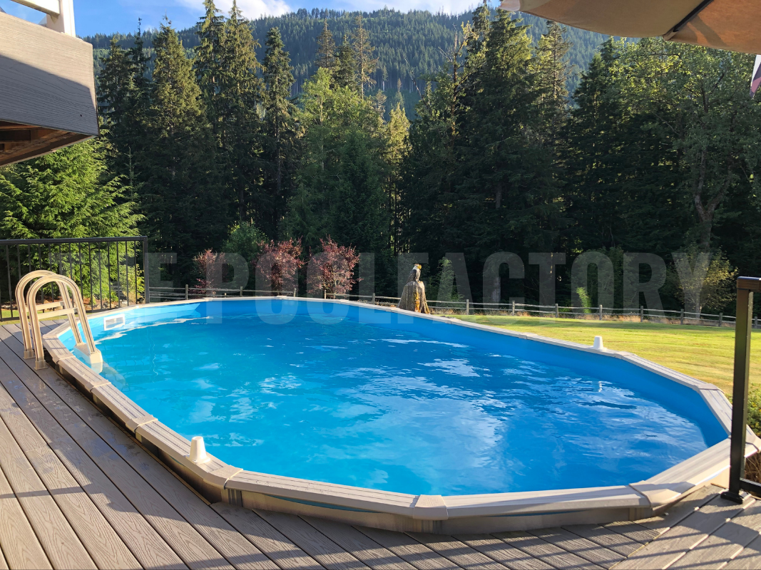Oval above ground swimming pool with a partial deck and large tall trees surrounding yard
