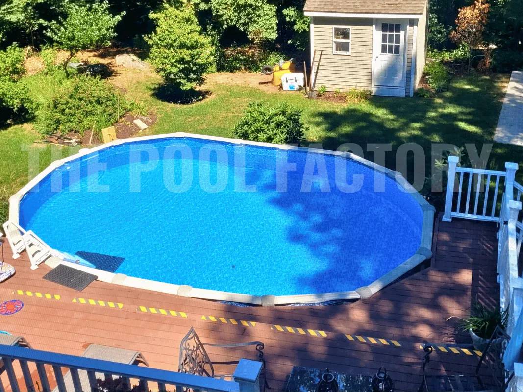 Saltwater 5000 Lazer Oval Pool featuring partial deck and blooming flowers nearby.