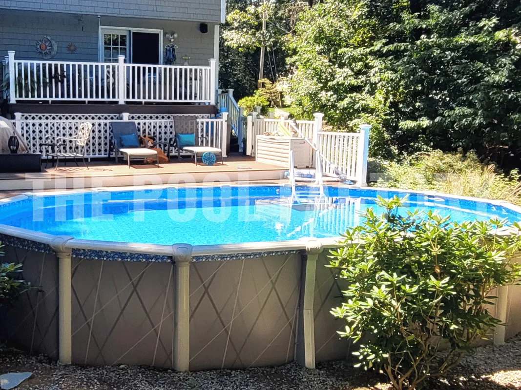 Saltwater 5000 Lazer Oval Pool with partial deck and neatly landscaped backyard area.