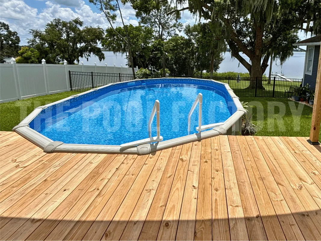 Saltwater 5000 Lazer Oval Pool with full deck and vibrant green lawn in the background.