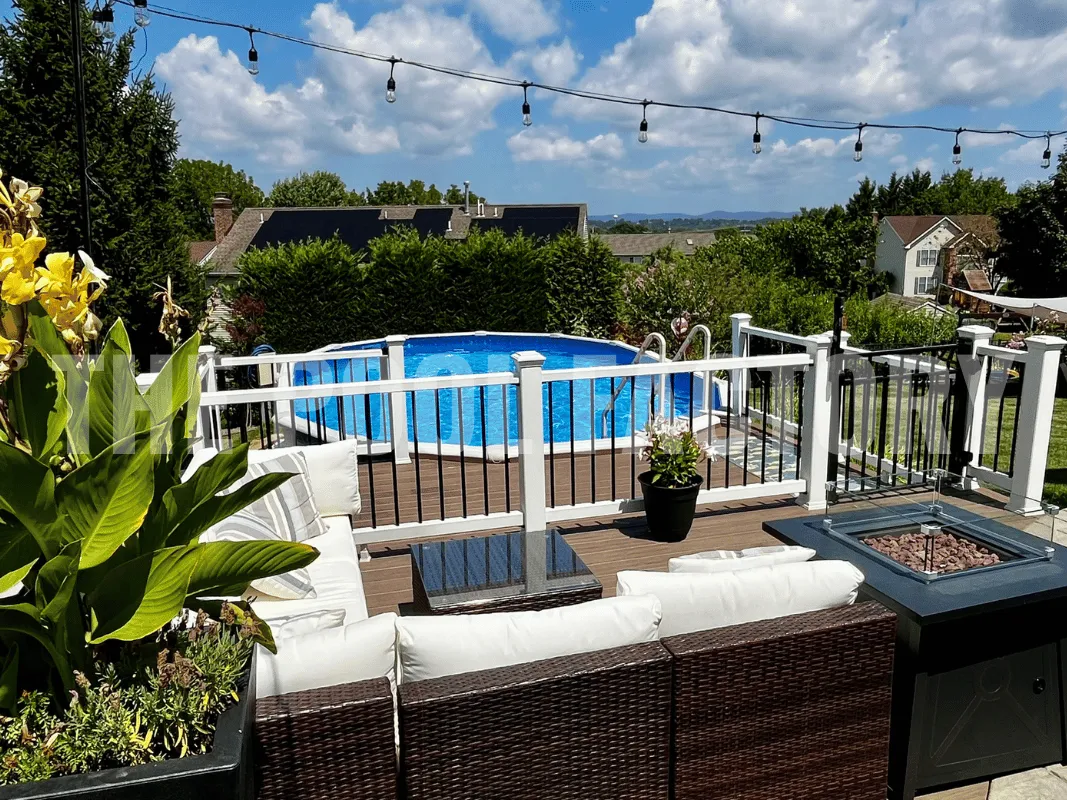 Above ground Saltwater 5000 Lazer Oval Pool with beautiful deck and shrubs.