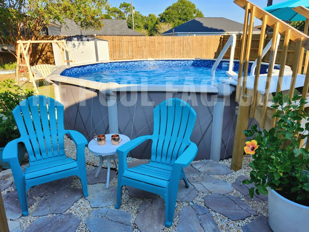 Above ground round saltwater swimming pool with surrounding stone patio.