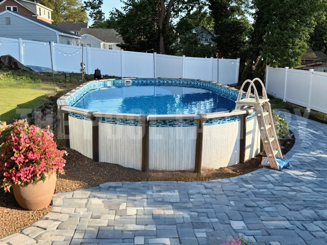Saltwater Titan Oval Pool with surrounding pavers and flower pots.  