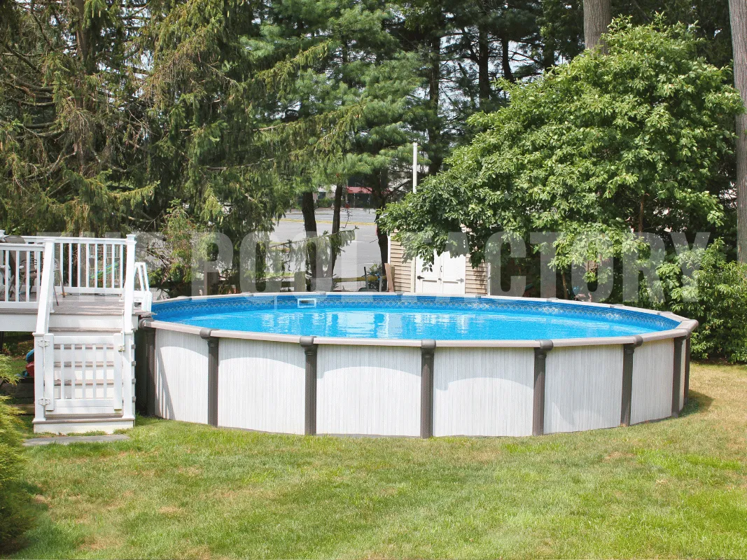 Saltwater Titan Round Pool with partial pool deck and surrounding grass and flowers.