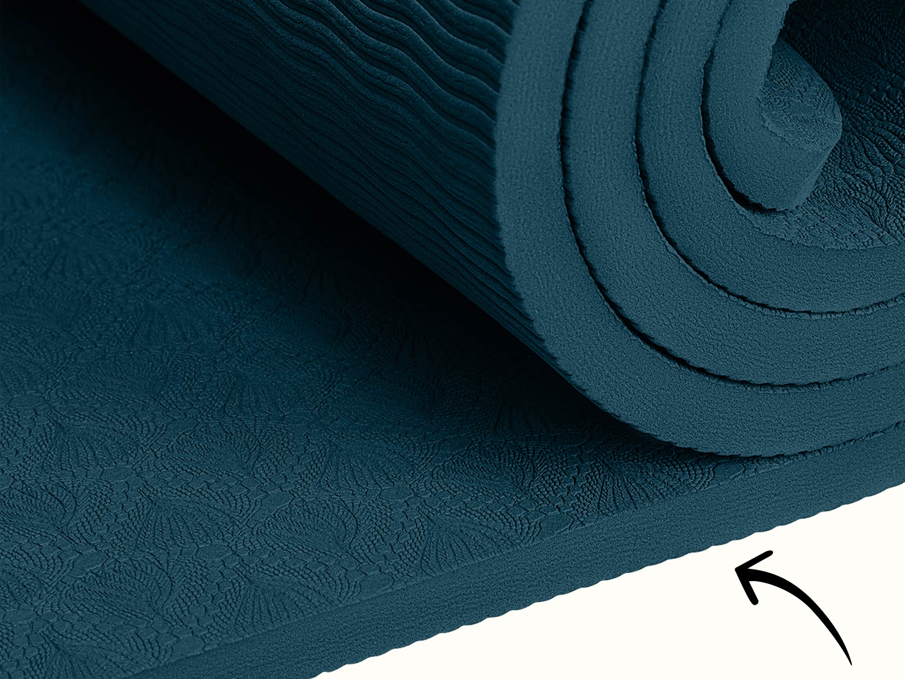 Close-up of the retrospec Zuma Yoga Mat in Ocean Blue, showing the embossed botanical surface texture and cushioned edge detail.