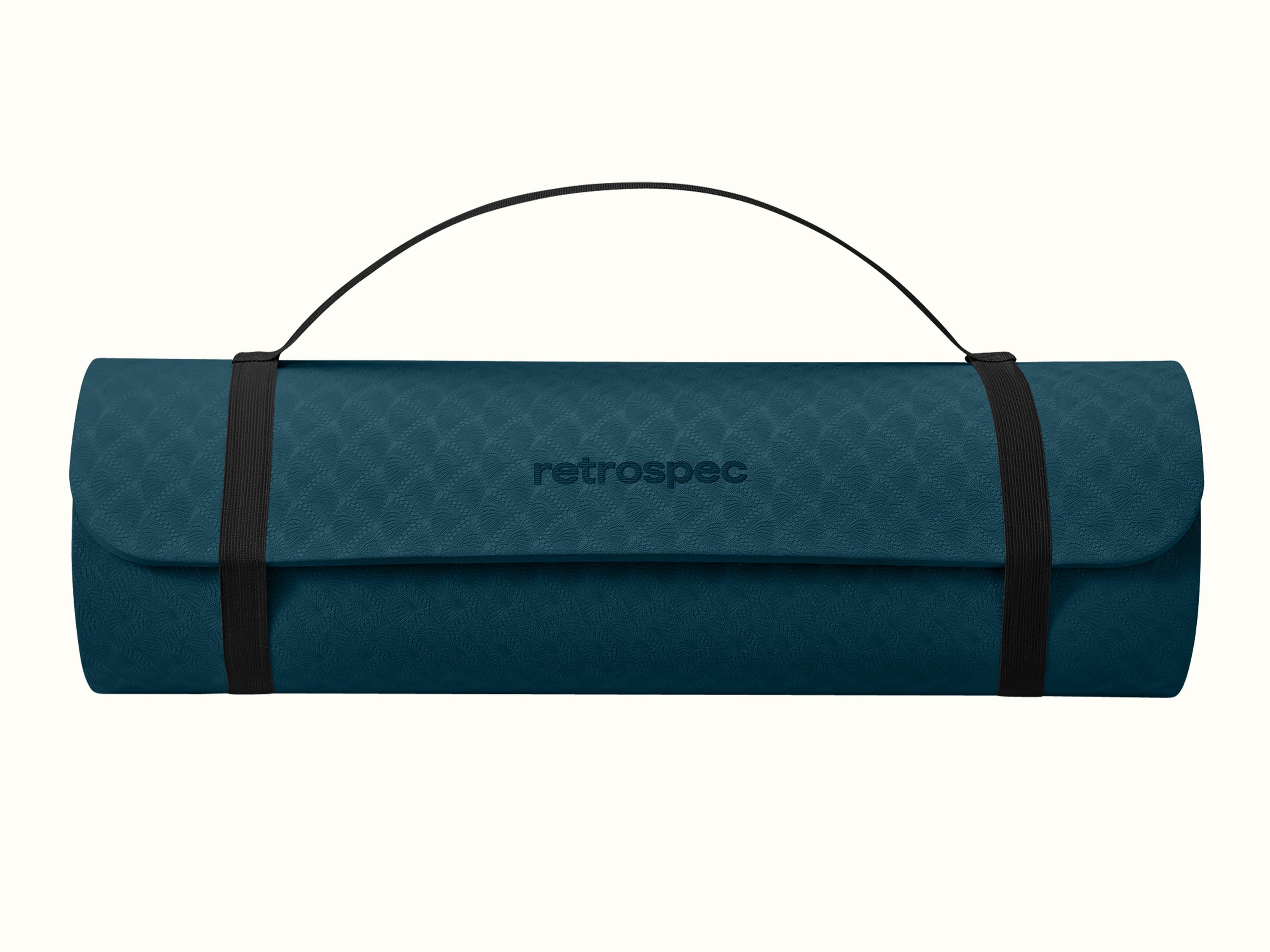 retrospec Zuma Yoga Mat rolled up and secured with black carry straps and a carrying handle, shown in Ocean Blue with an embossed wave pattern and retrospec logo on front.