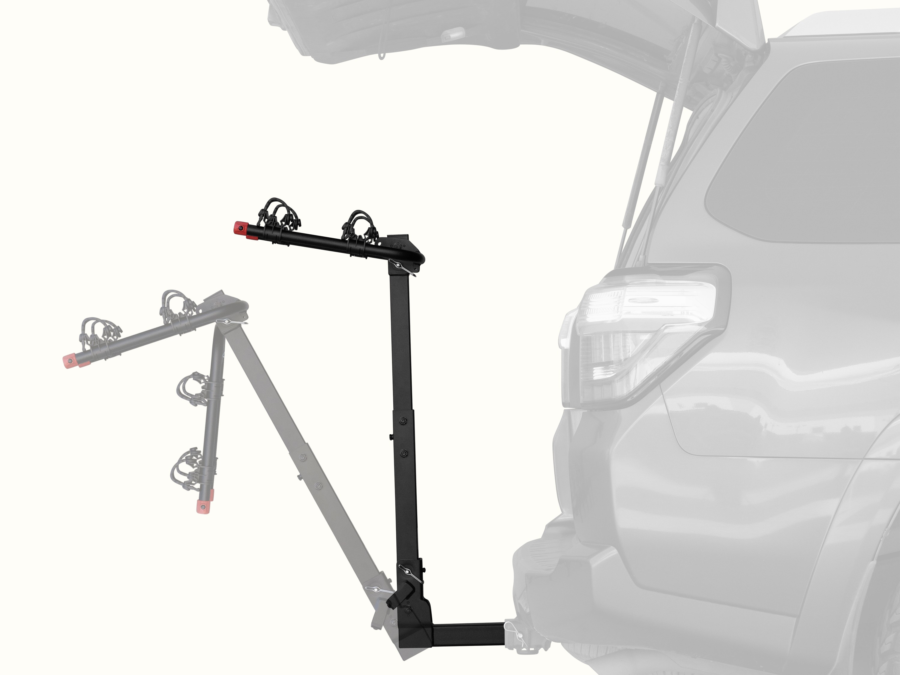 retrospec Lenox Hitch Mount Car Bike Rack (2-Bike) shown in both upright and tilted-down positions on the rear of an SUV with its trunk open, demonstrating the rack's tilt-away feature for easy cargo access.