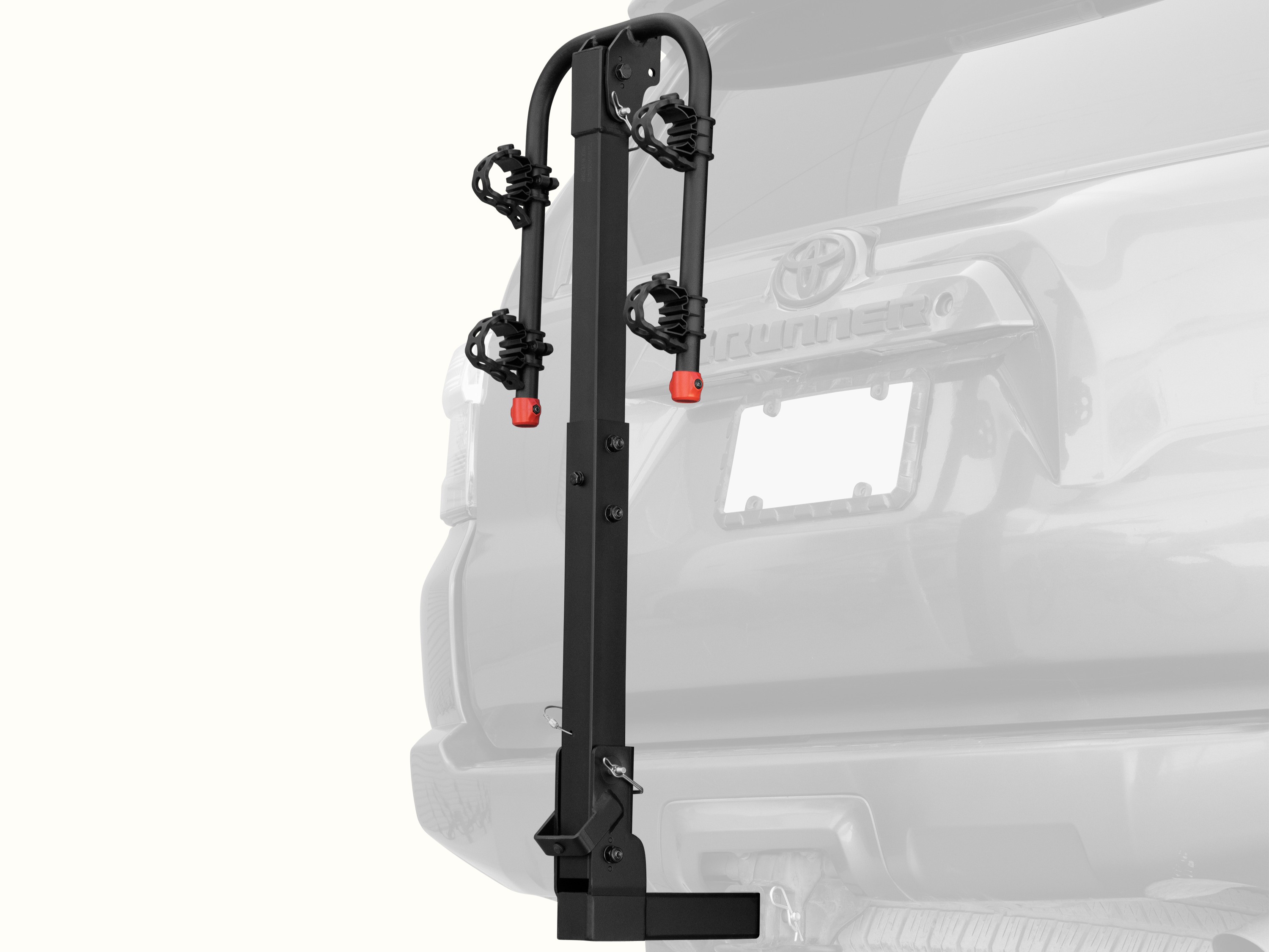 retrospec Lenox Hitch Mount Car Bike Rack (2-4 Bikes) installed on the rear of a Toyota 4Runner, shown empty in the folded upright position with cradle arms raised and red safety caps in place.
