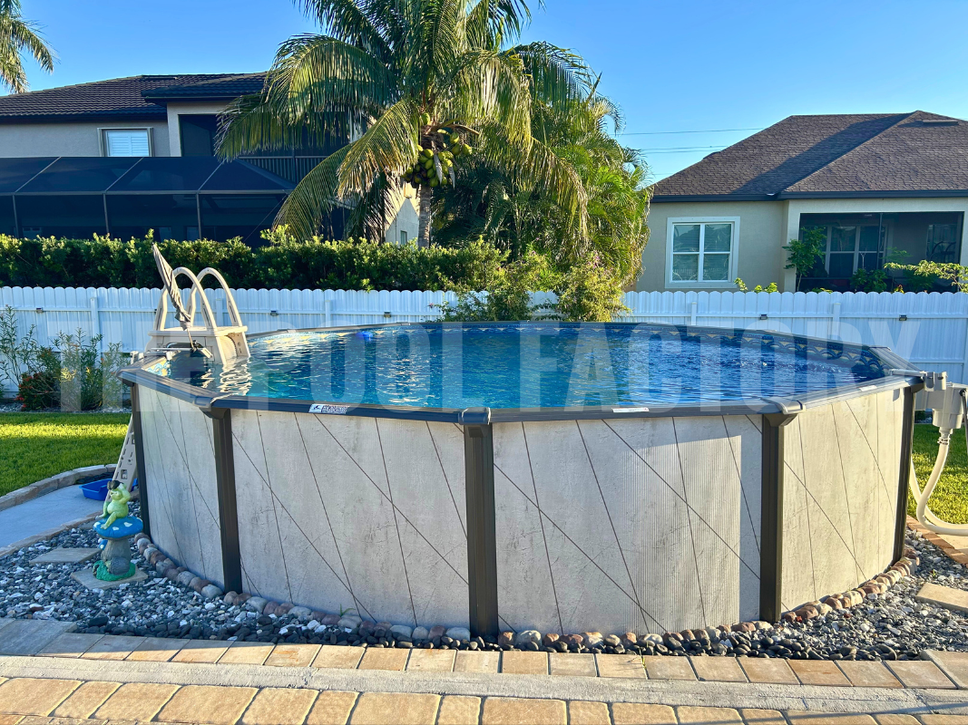 Del Rey above ground round swimming pool with surrounding pavers and unique landscaping around the pool. 