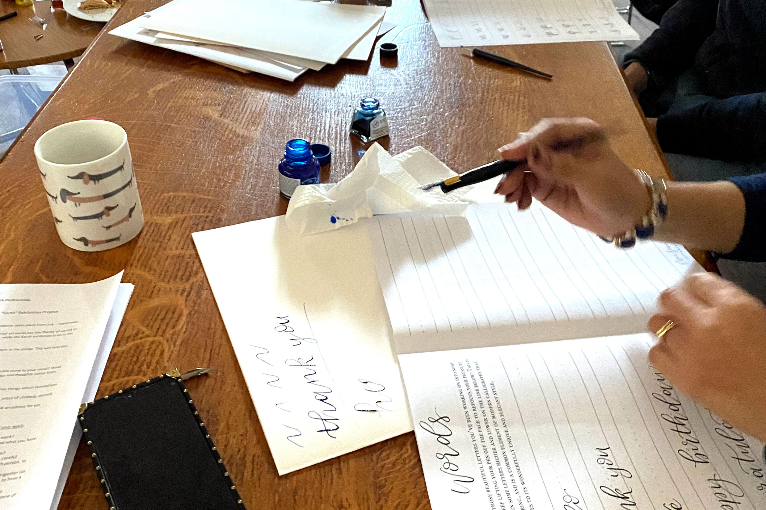 An image of a person drawing with a calligraphy pen 