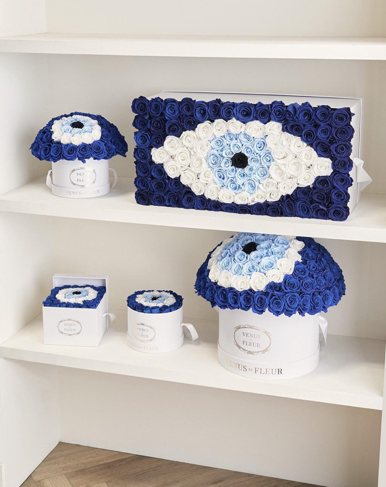 Display of the evil eye collection, different shaped boxes with roses arrangement in the shape of the evil eye