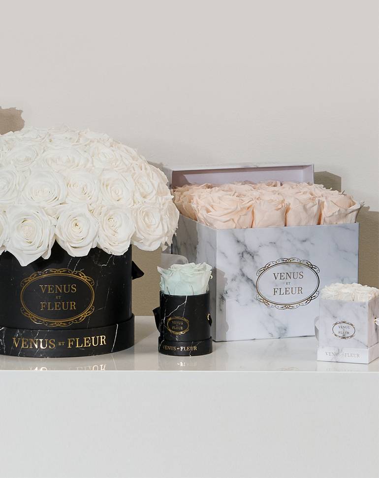 Marble printed gift box with pink roses, and another black round box with white roses