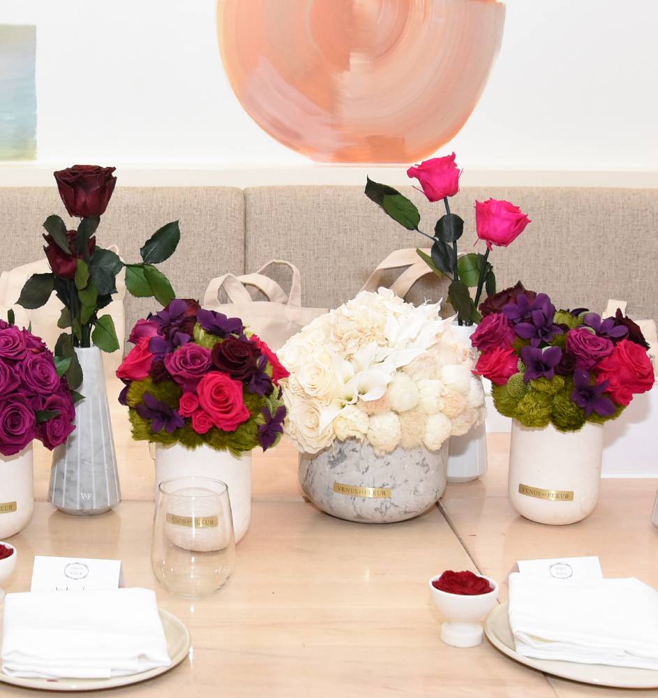 Array of different Venus et Fleur flower arrangements laid across a table 