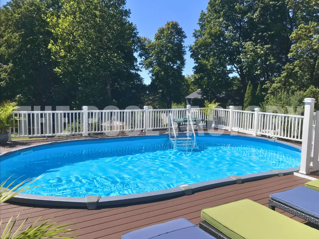 Oval saltwater above ground pool with crystal clear water surrounded by Trex deck