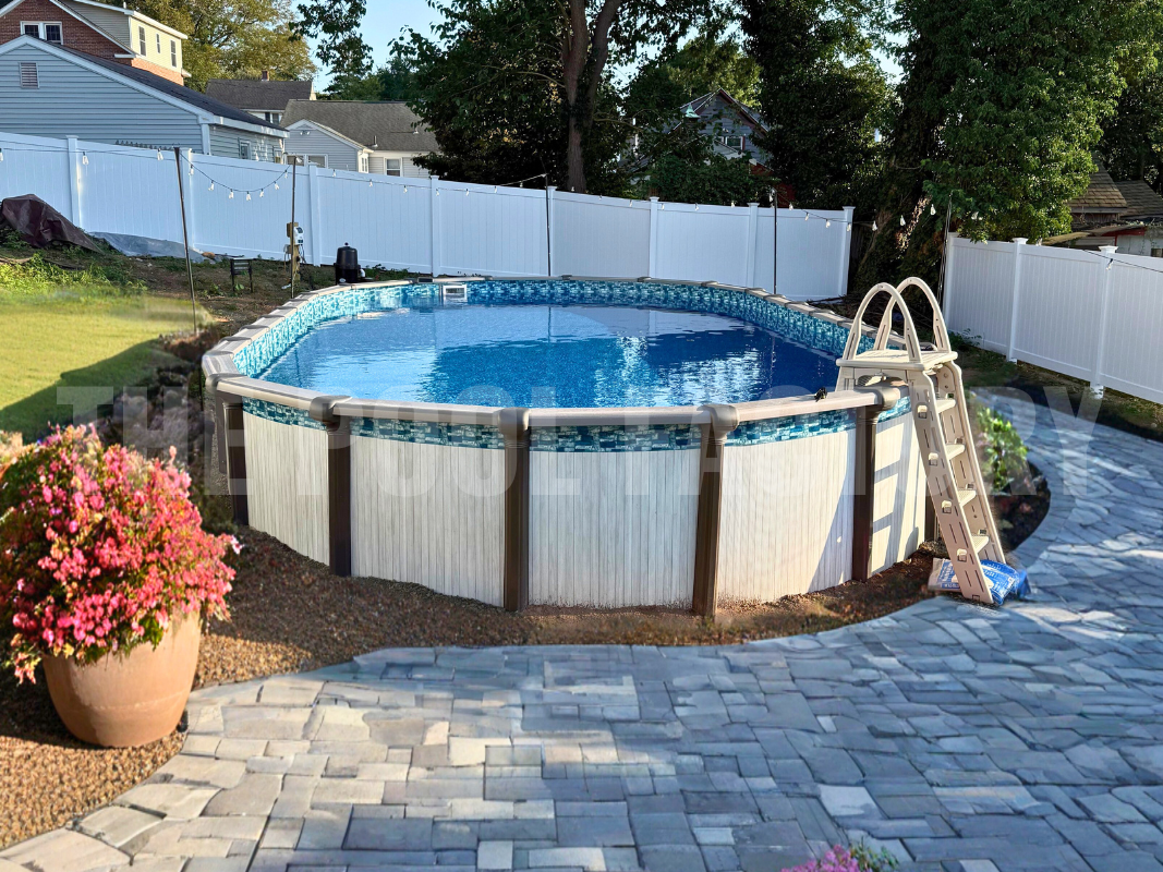 Saltwater Titan Oval Pool with surrounding pavers and flower pots.  