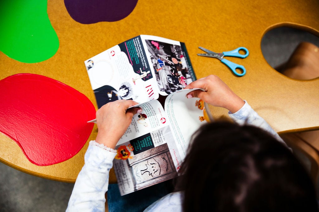 A child uses scissors to create the 3D Activity Trail 