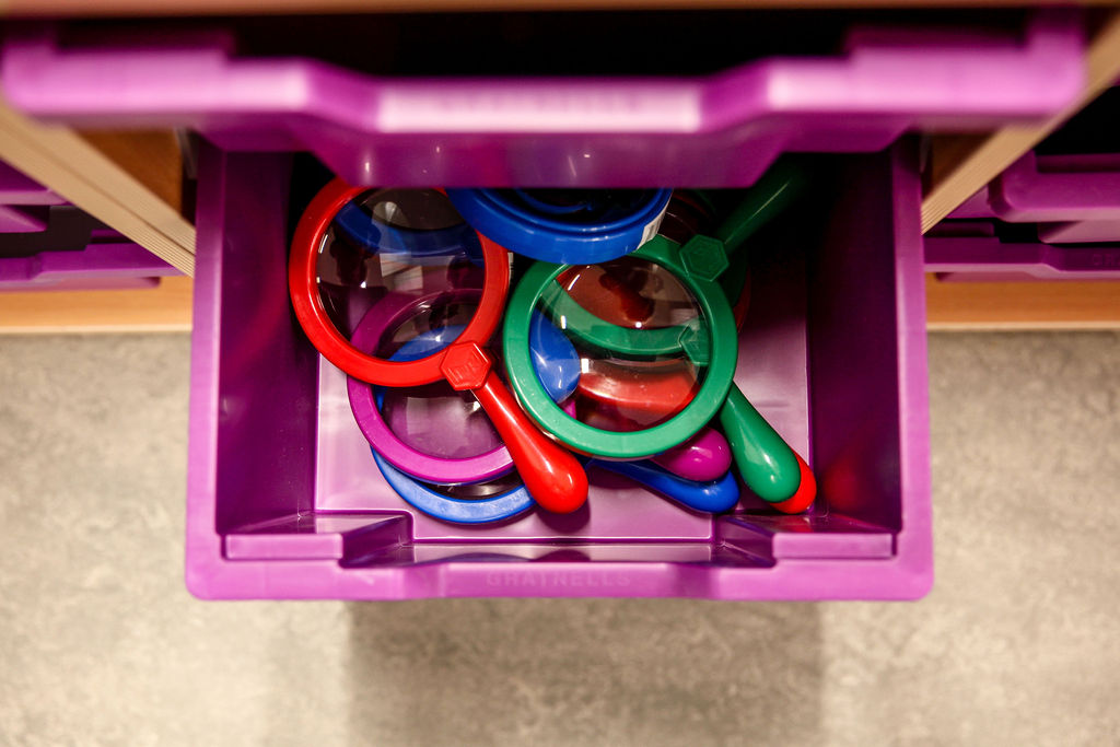 A draw of coloured magnifying glasses in a draw in the Family Activity Space 