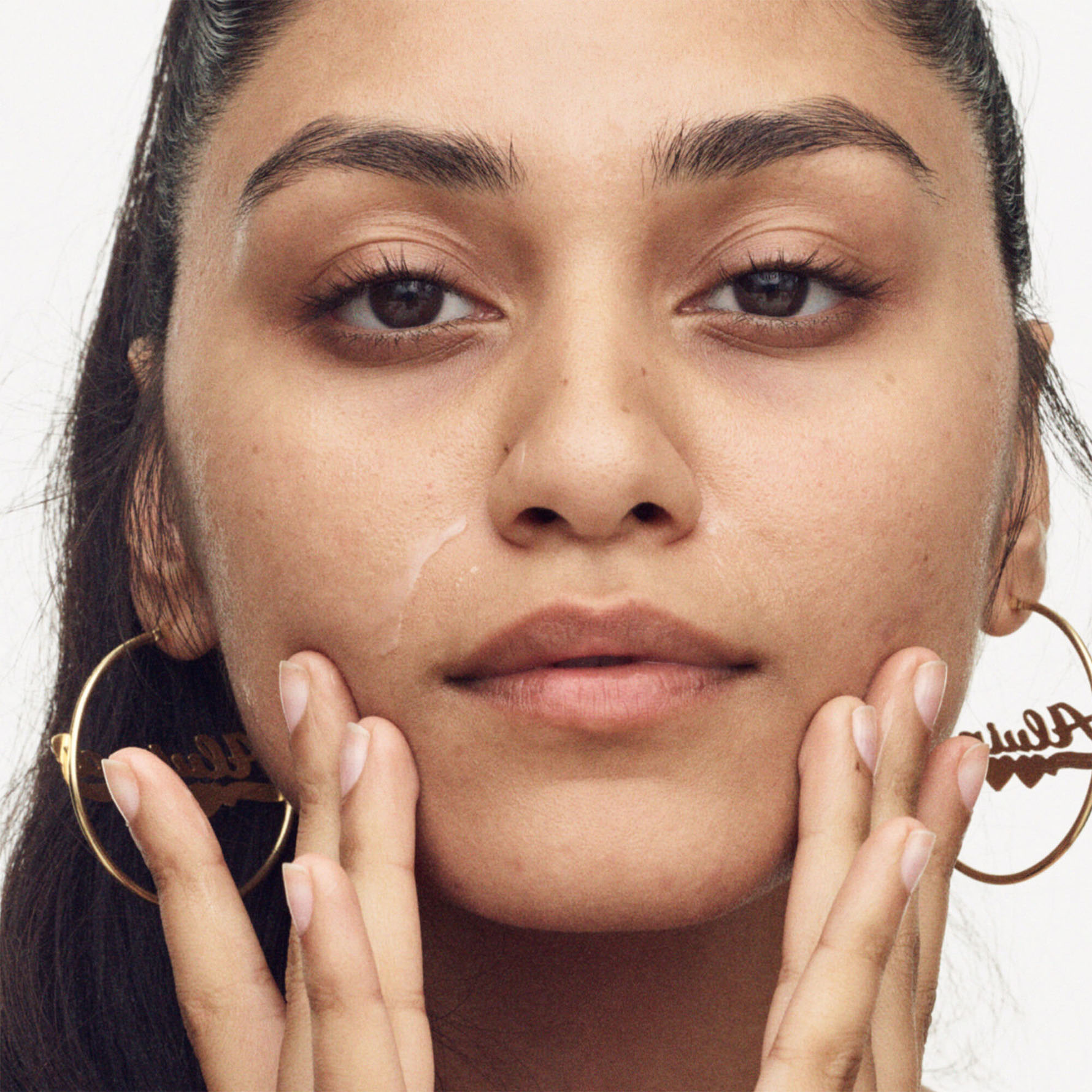 Model applying Watch Ya Tone to her face.