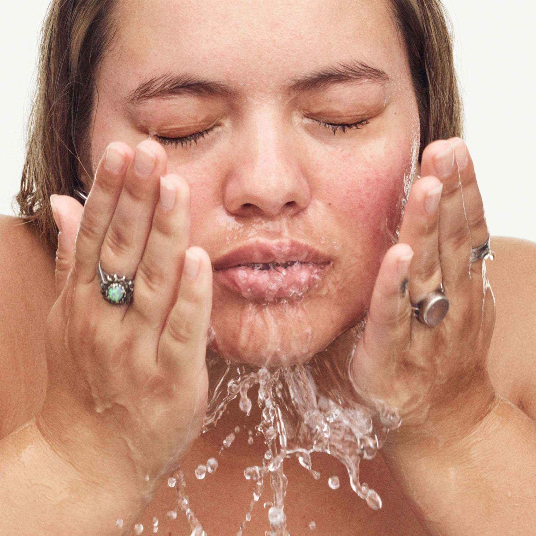 Model washing face with Melt Awf cleanser. Model washing face with Melt Awf cleanser.