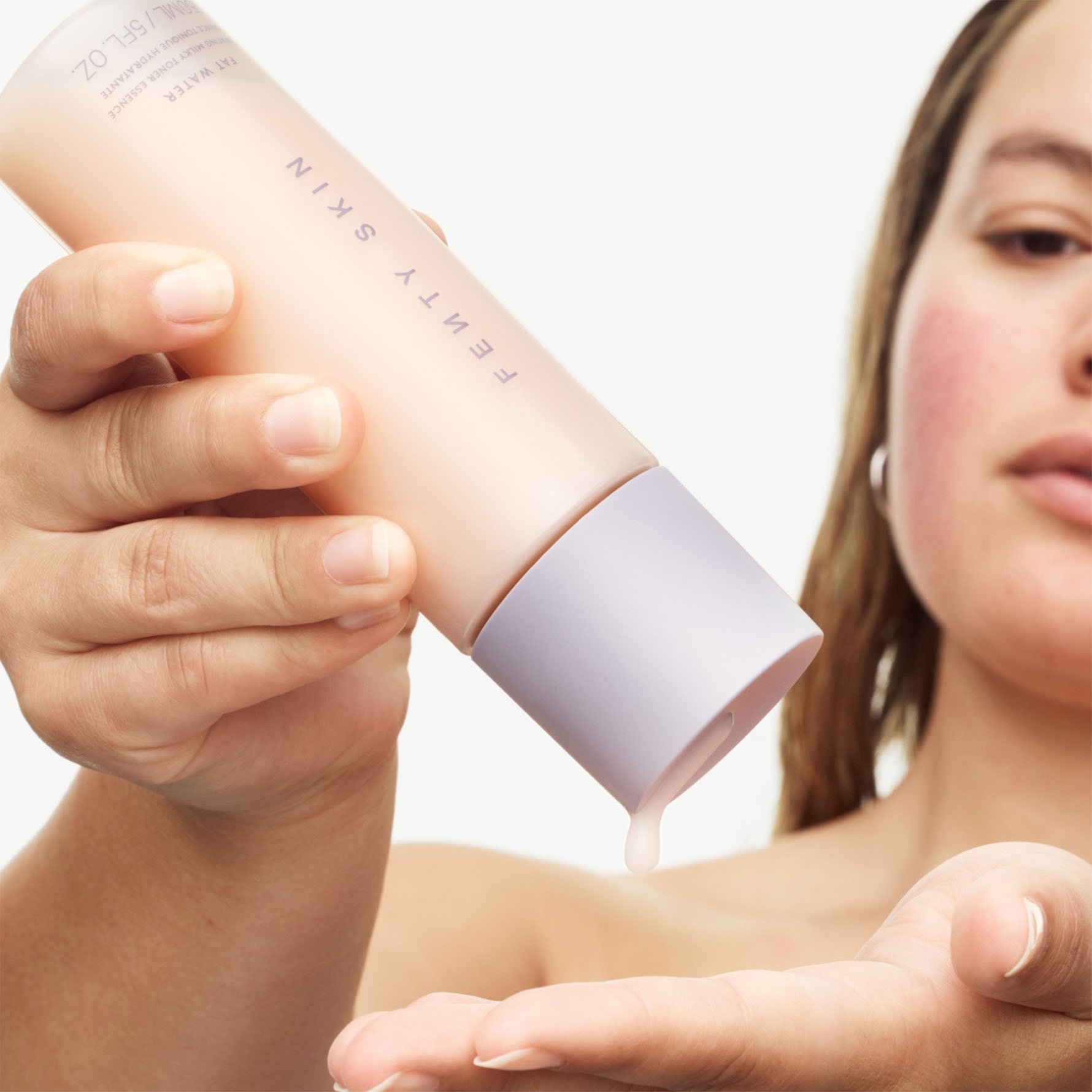 Model squeezing Fat Water Milky Toner Essence into hands, Model squeezing Fat Water Milky Toner Essence into hands,