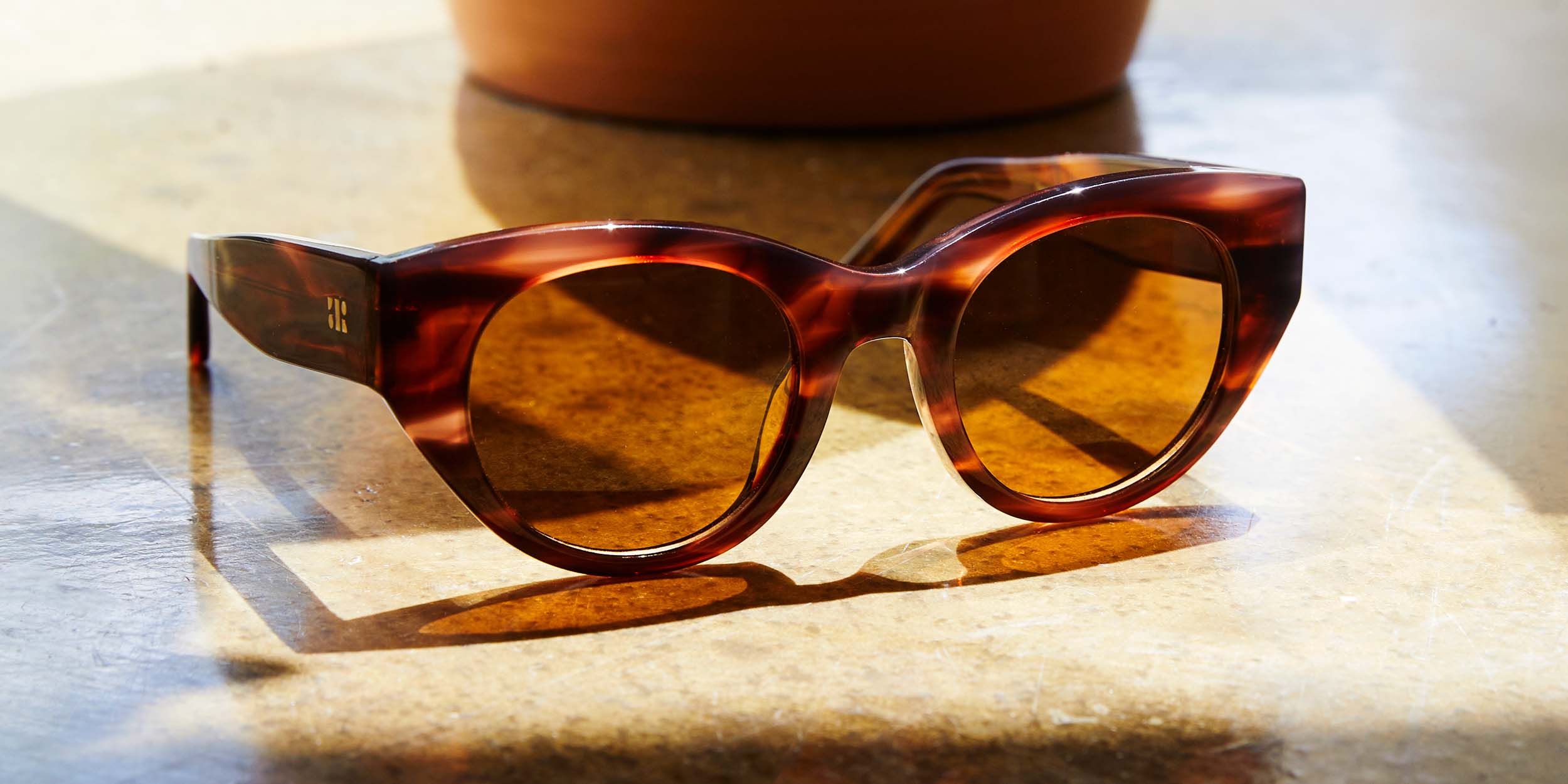 Photo Details of Jackie Clear Burgundy & Blue Marble Reading Glasses in a room