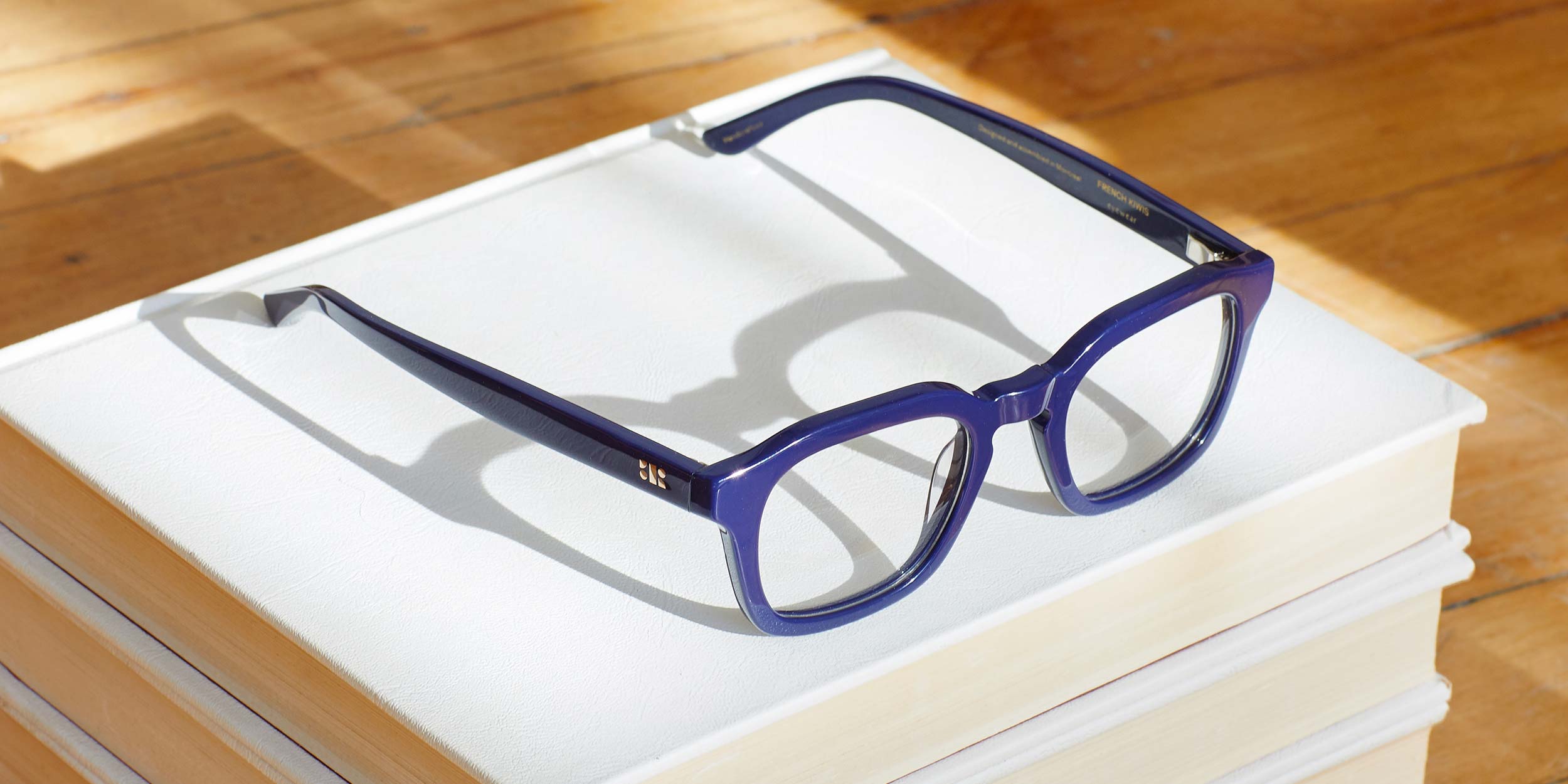 Photo Details of Oscar Clear Dark Olive Reading Glasses in a room