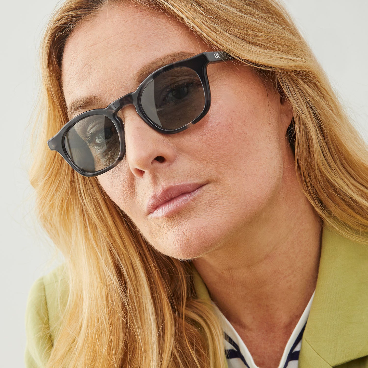 Photo of a man or woman wearing Thomas Sun Clear Dark Olive Sun Glasses by French Kiwis