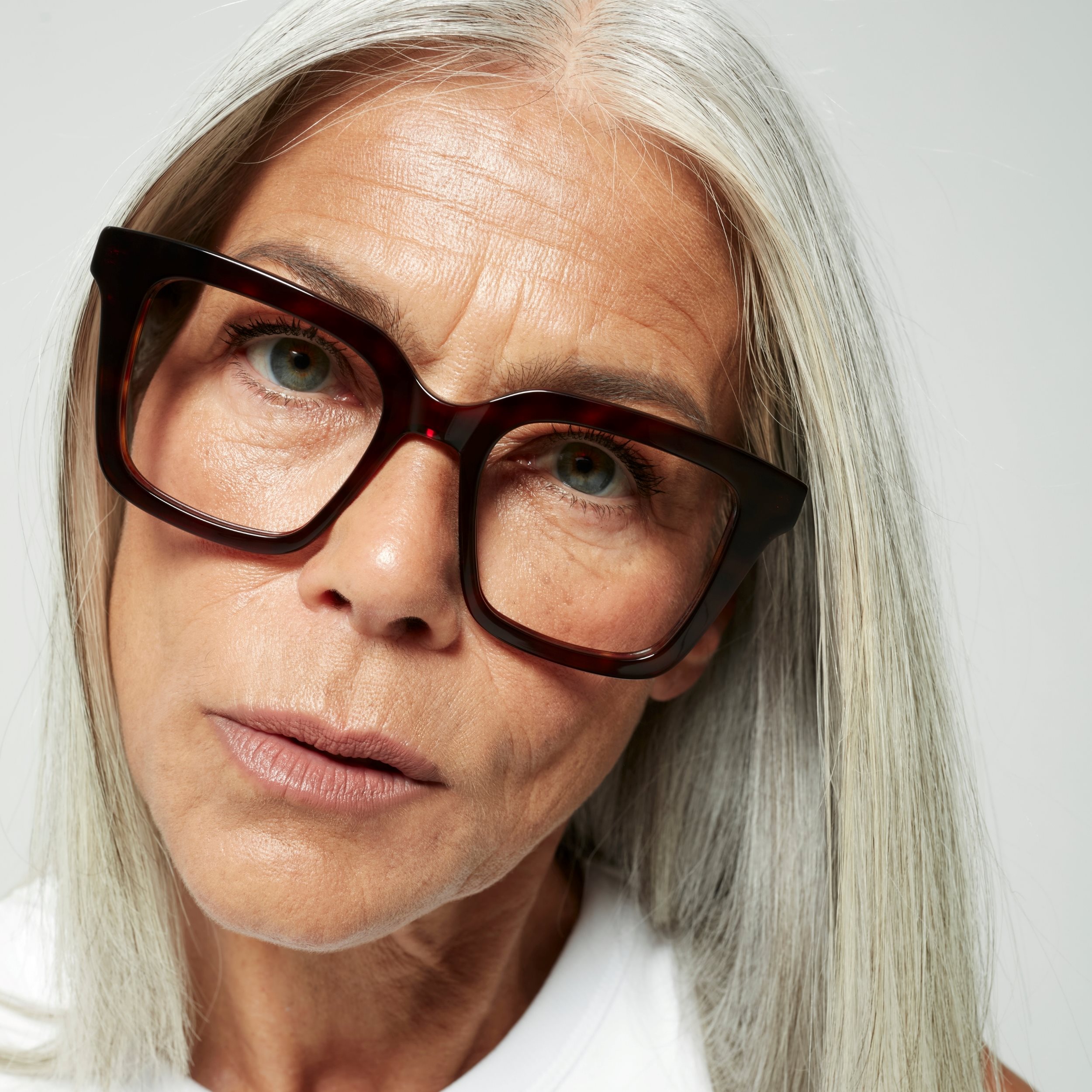 Photo of a man or woman wearing Jolie Blue Light Dark Red Blue Light Glasses by French Kiwis