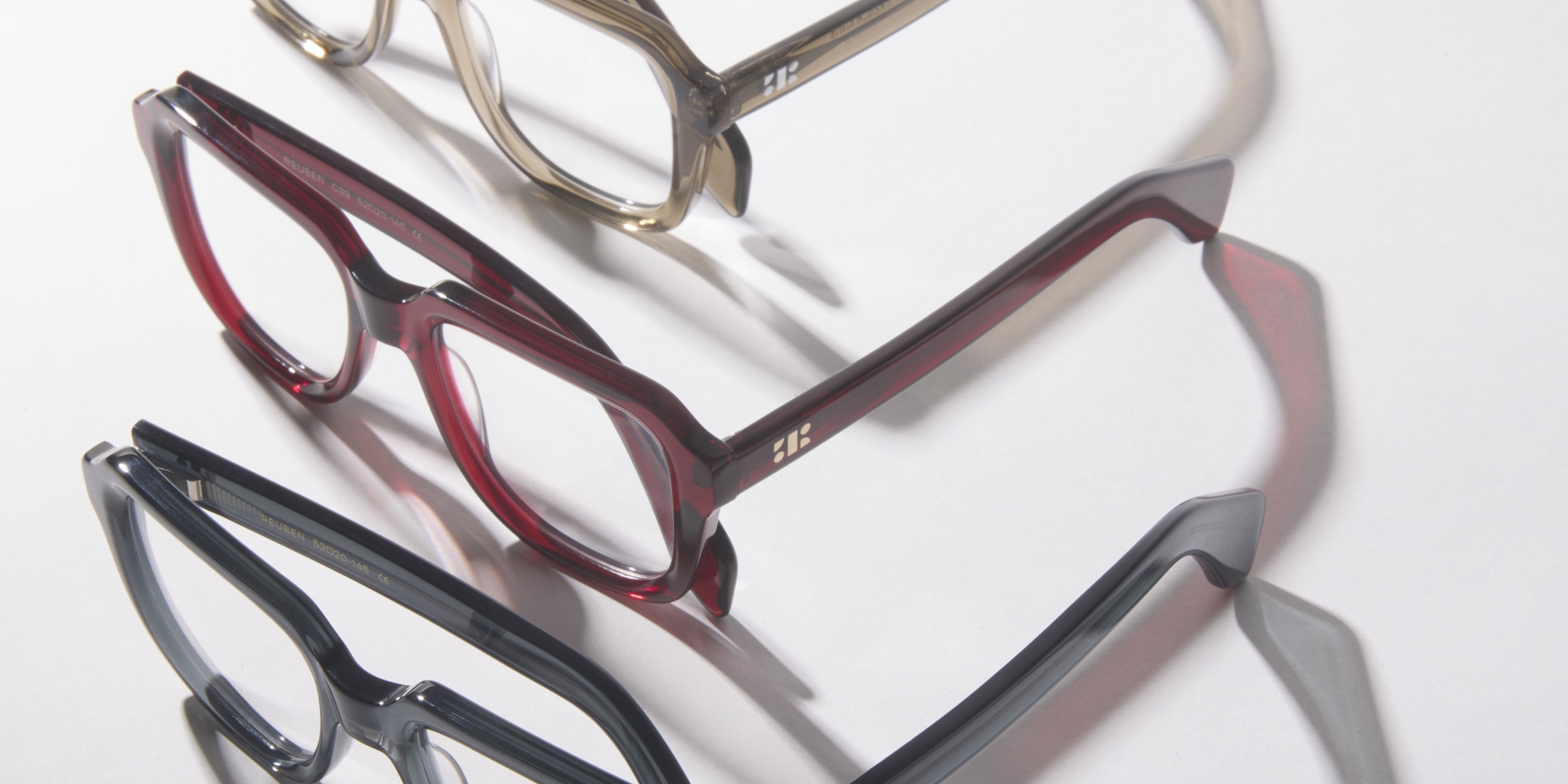 Photo Details of Reuben Clear Dark Grey Reading Glasses in a room