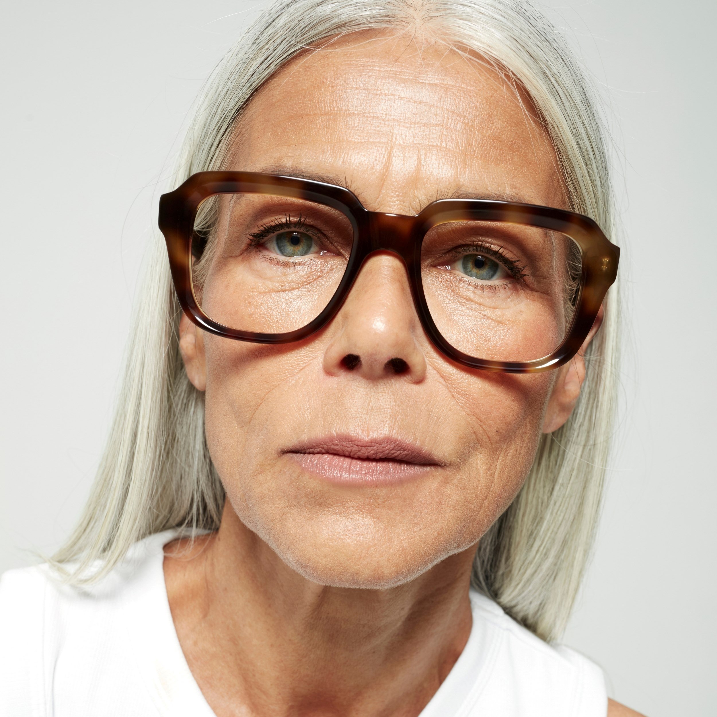Photo of a man or woman wearing Reuben Blue Light Clear Taupe Blue Light Glasses by French Kiwis