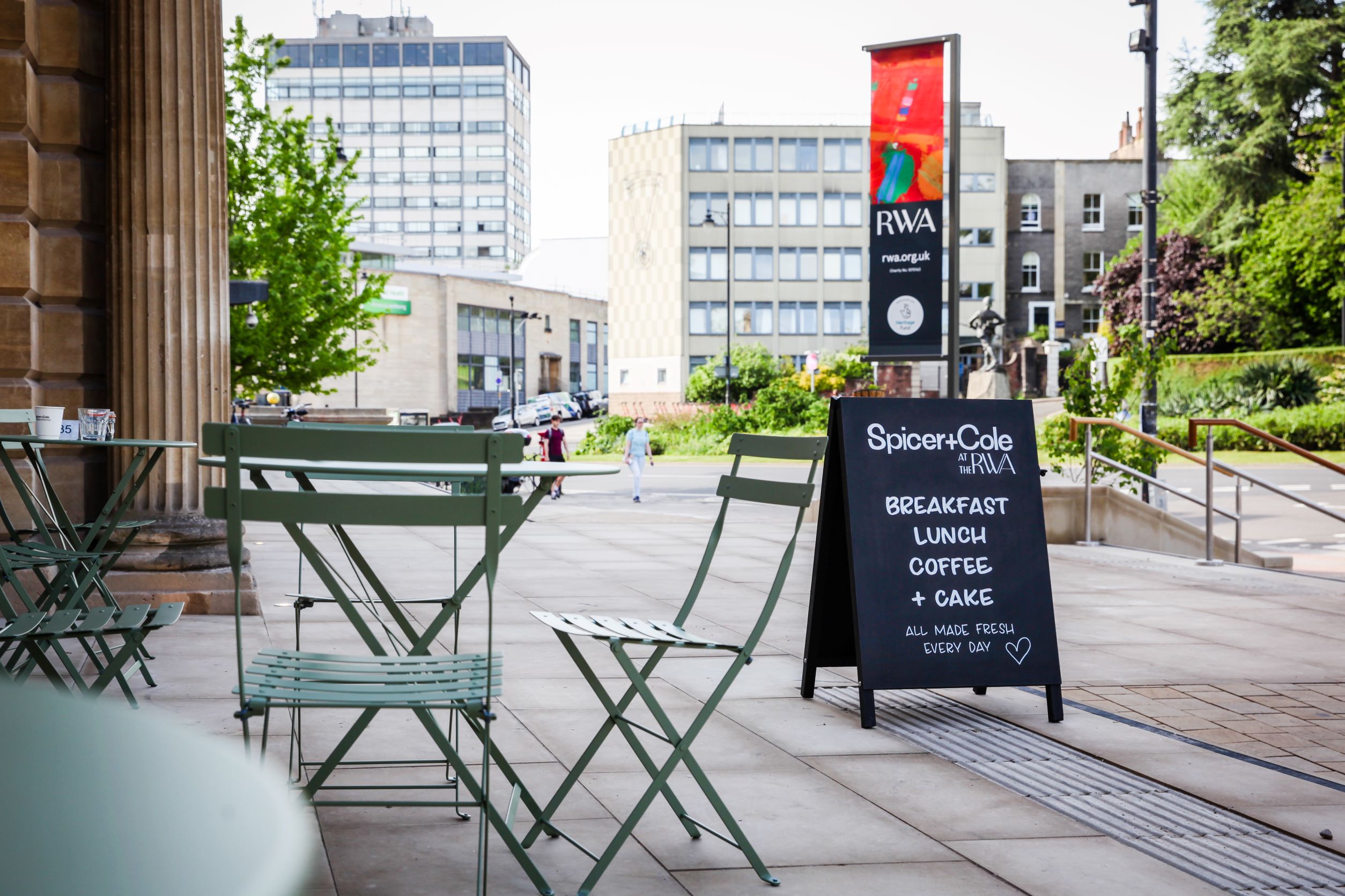 Tables and chairs on the RWA forecourt looking out onto Clifton Park Street 