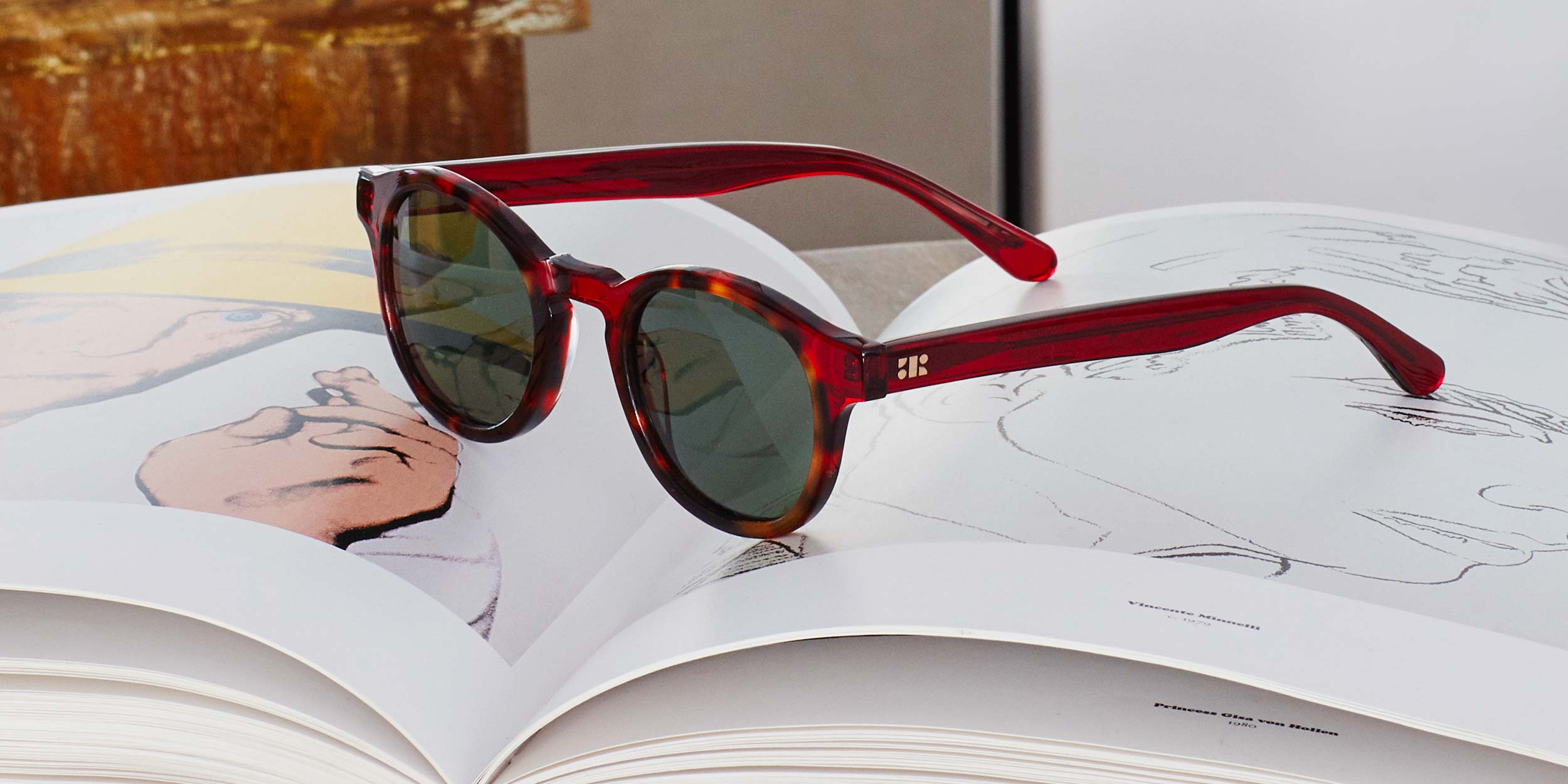 Photo Details of Alexis Sun Clear Dark Olive and Camo Sun Glasses in a room