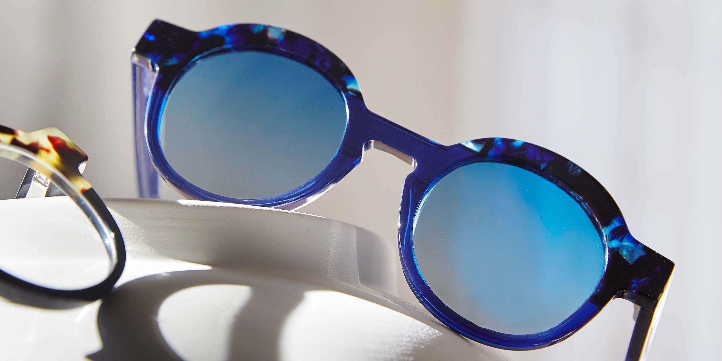 Photo Details of Charlotte Sun Clear Mauve & Tortoise Sun Glasses in a room