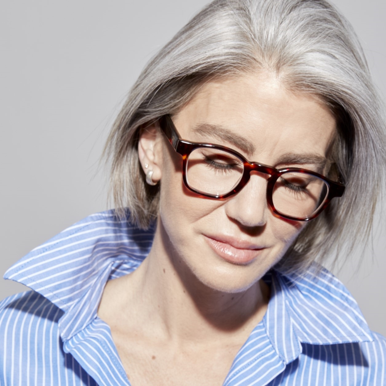 Photo of a man or woman wearing Enzo Clear Stone Blue Reading Glasses by French Kiwis