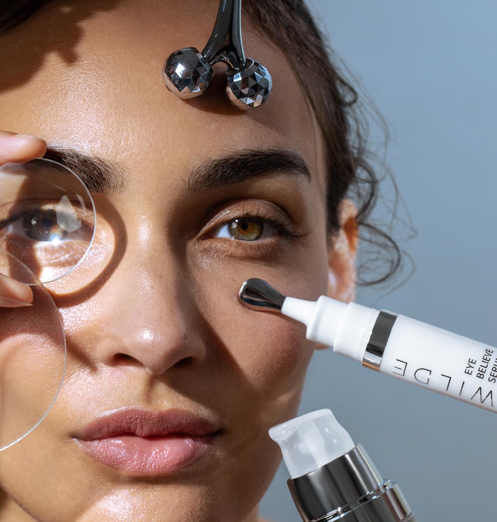 Woman Holding Magnifying Glass And Eye Serum