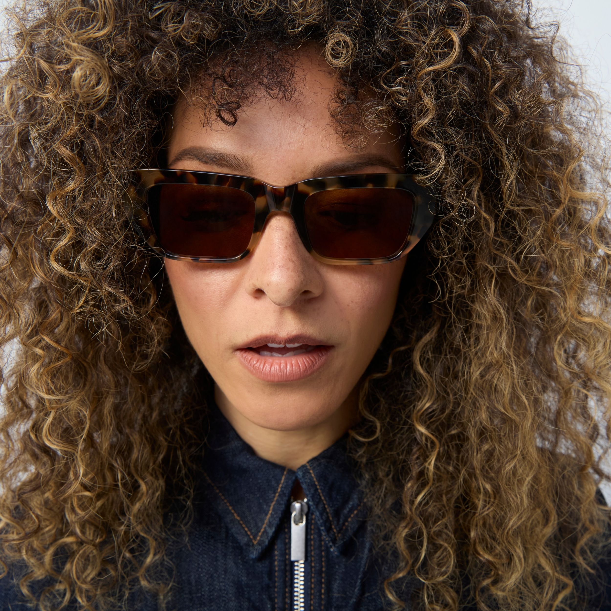 Photo of a man or woman wearing Kai Sun Black Sun Glasses by French Kiwis