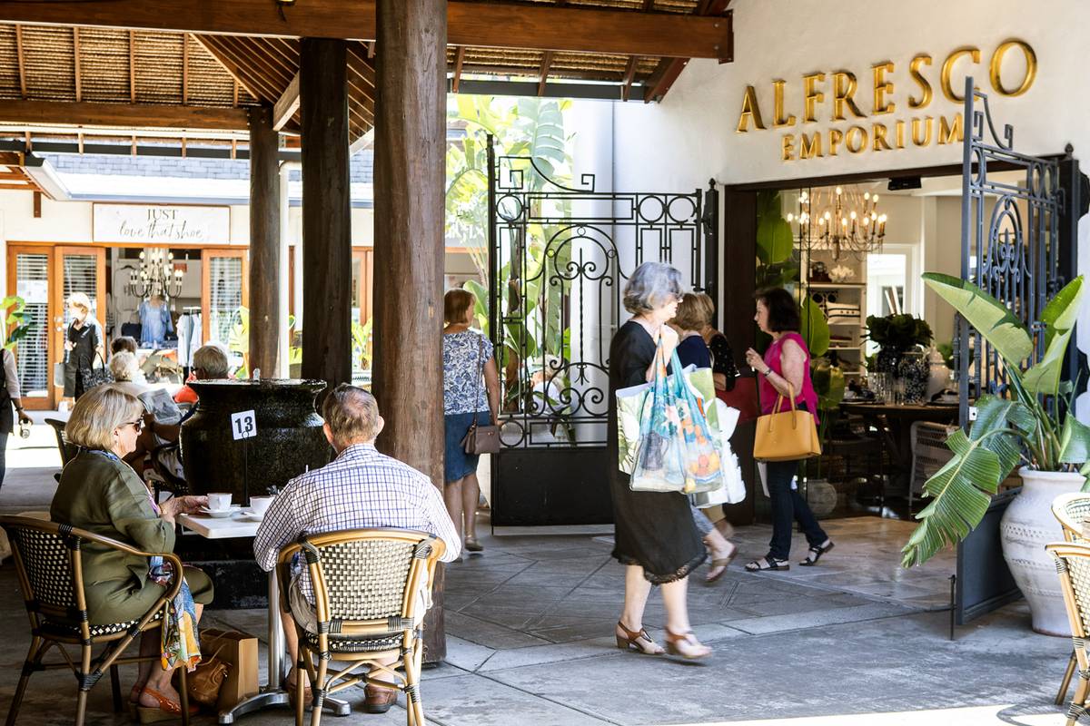 Customers seated at a table enjoying coffee outside the entrance to our Bundall, QLD store.