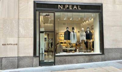 N.Peal Rockefeller storefront at 620 Fifth Avenue, featuring a large display window with mannequins dressed in luxury knitwear and outerwear